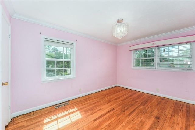 1007 Atlantic Ave, Waycross, GA 31501 - unfurnished room with ornamental molding, a chandelier, and wood finished floors