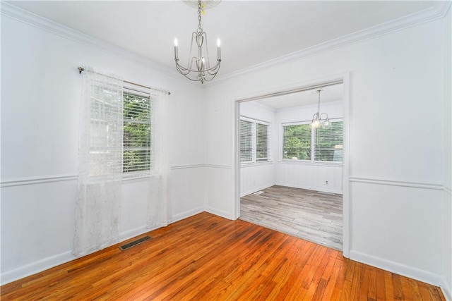 1007 Atlantic Ave, Waycross, GA 31501 - empty room with a chandelier, ornamental molding, hardwood / wood-style floors, and healthy amount of natural light