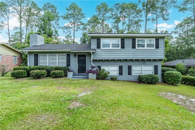 1007 Atlantic Ave, Waycross, GA 31501 - tri-level home featuring brick siding, a front lawn, and a chimney