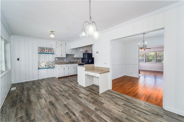 1007 Atlantic Ave, Waycross, GA 31501 - kitchen with a chandelier, black fridge with ice dispenser, crown molding, dark wood-style floors, and hanging light fixtures