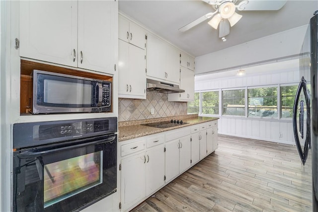 1007 Atlantic Ave, Waycross, GA 31501 - kitchen featuring black appliances, under cabinet range hood, white cabinets, tasteful backsplash, and a ceiling fan