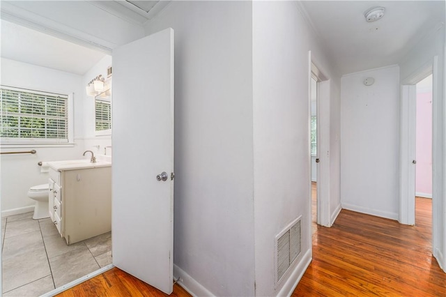 1007 Atlantic Ave, Waycross, GA 31501 - hallway with light wood-type flooring and a sink