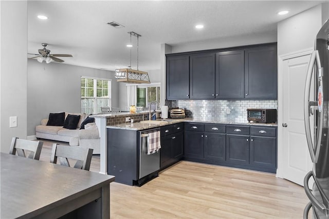 kitchen featuring hanging light fixtures, ceiling fan, appliances with stainless steel finishes, light hardwood / wood-style floors, and kitchen peninsula