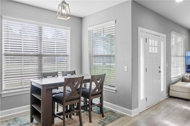 dining space with light wood-type flooring