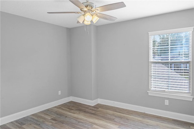 empty room with ceiling fan and hardwood / wood-style floors