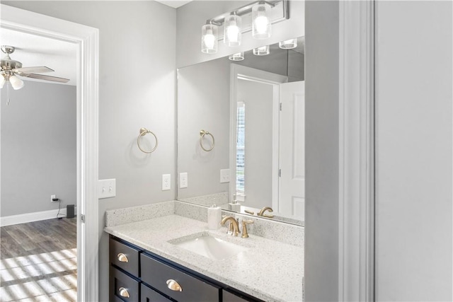 bathroom with ceiling fan, vanity, and hardwood / wood-style flooring