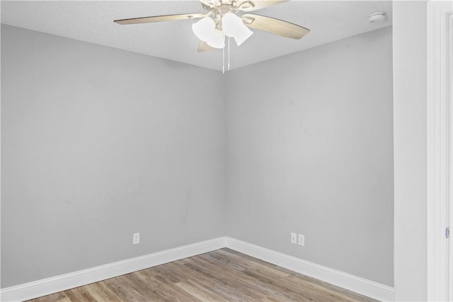 unfurnished room with hardwood / wood-style flooring and ceiling fan