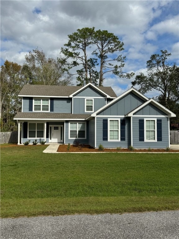 view of front of house with a front yard and a porch