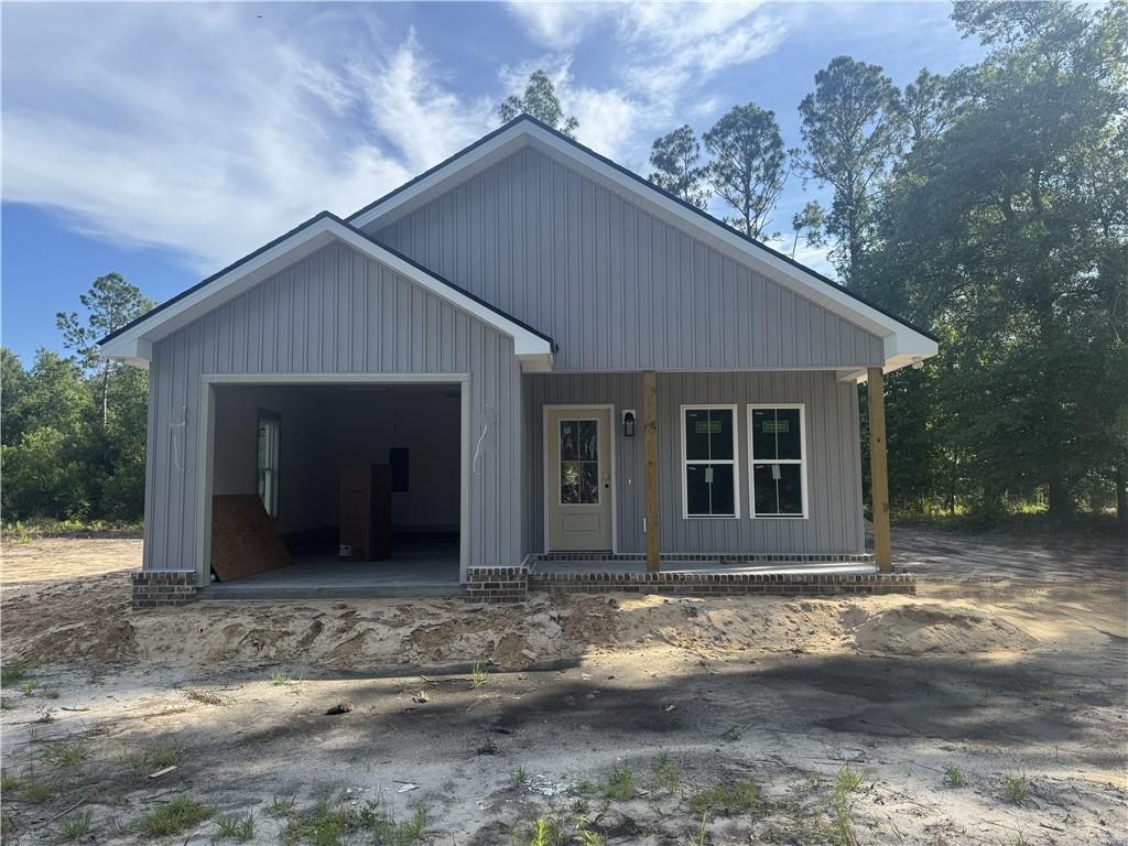 158 N Deborah Cir, Jesup, GA 31546 - view of front facade with a garage and a porch
