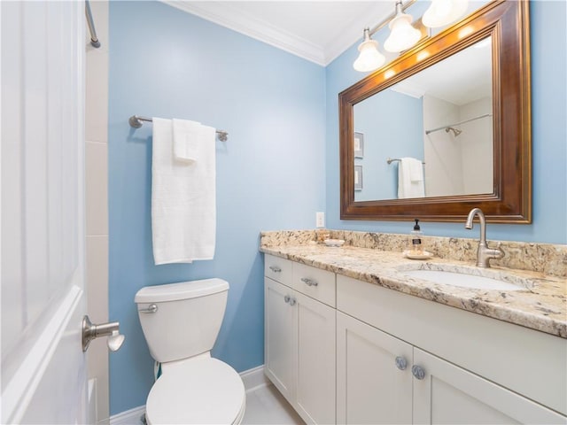 bathroom with crown molding, vanity, and toilet