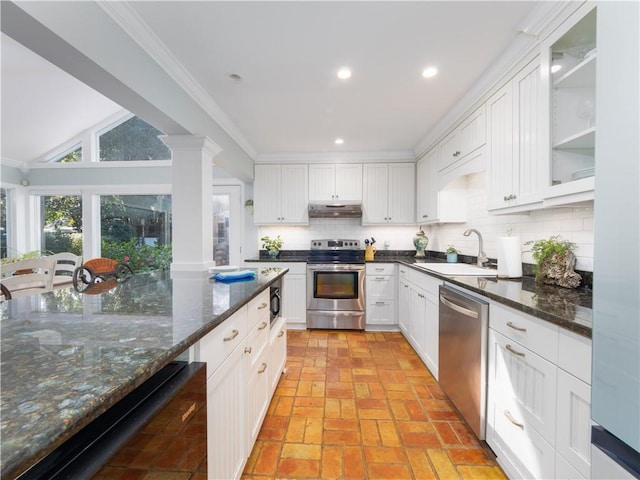 kitchen featuring white cabinetry, sink, backsplash, ornamental molding, and stainless steel appliances