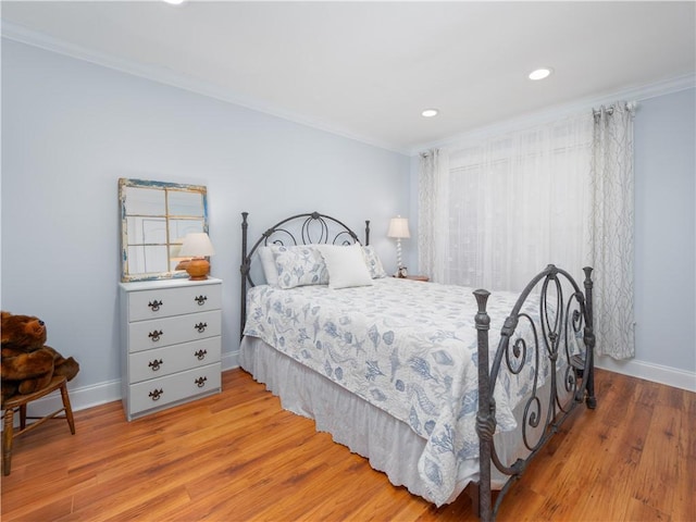 bedroom with ornamental molding and light wood-type flooring