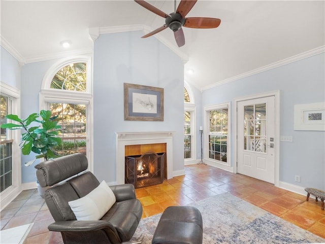 tiled living room with ceiling fan, ornamental molding, and high vaulted ceiling