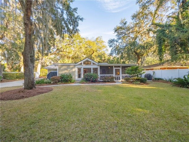 single story home featuring a front yard and a sunroom