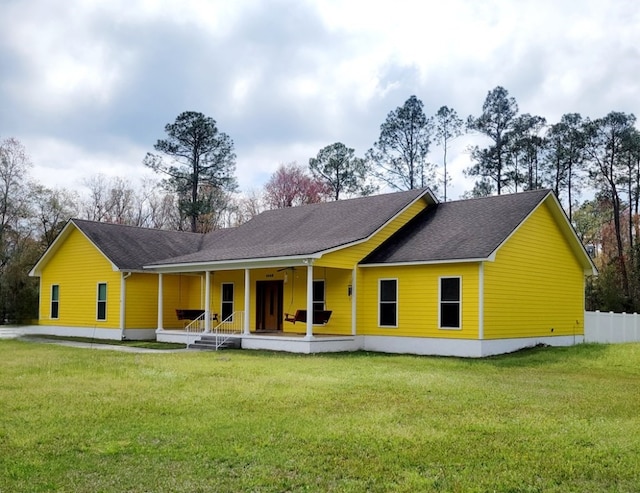 back of house featuring a porch and a yard