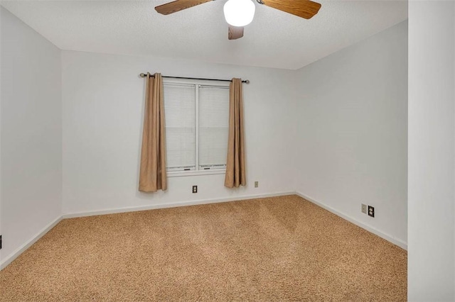 carpeted empty room with ceiling fan and a textured ceiling