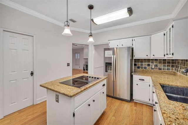 kitchen with a kitchen island, stainless steel fridge with ice dispenser, light hardwood / wood-style flooring, black electric cooktop, and white cabinets