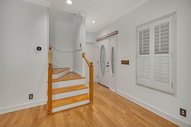 staircase featuring wood-type flooring and crown molding