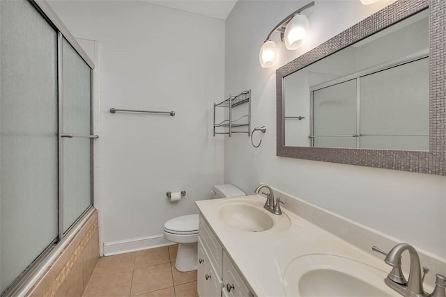 full bathroom with tile patterned flooring, vanity, toilet, and enclosed tub / shower combo