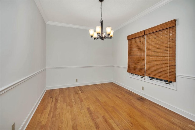 unfurnished room with a chandelier, wood-type flooring, and ornamental molding