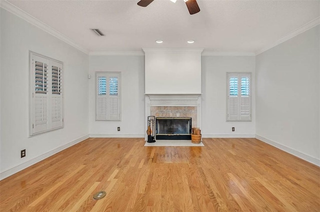 unfurnished living room with ceiling fan, crown molding, and light hardwood / wood-style flooring