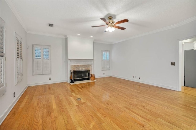 unfurnished living room with ceiling fan, light hardwood / wood-style floors, a textured ceiling, and ornamental molding