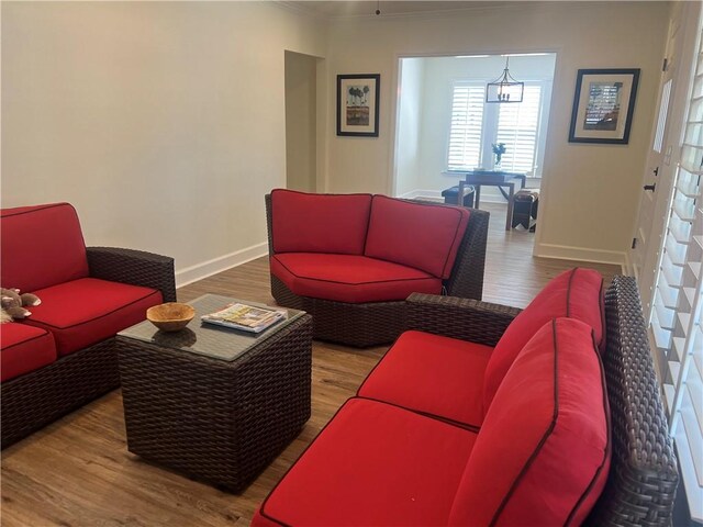 living room featuring hardwood / wood-style flooring, ceiling fan, a healthy amount of sunlight, and crown molding