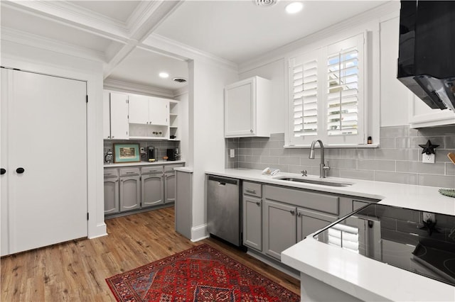 kitchen with gray cabinets, coffered ceiling, sink, and stainless steel dishwasher