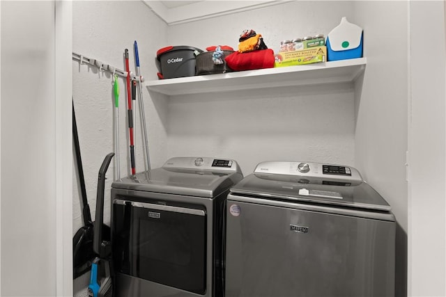 clothes washing area with washing machine and clothes dryer