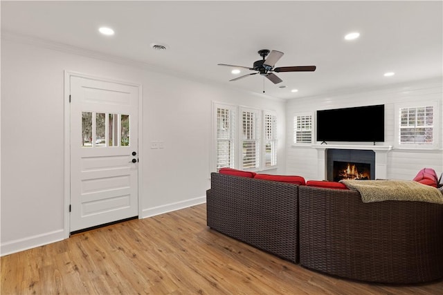 living room featuring ornamental molding, a wealth of natural light, and hardwood / wood-style floors