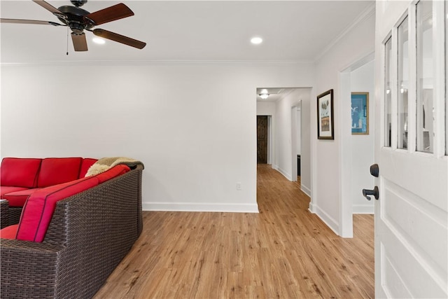 sitting room featuring crown molding, ceiling fan, and light wood-type flooring