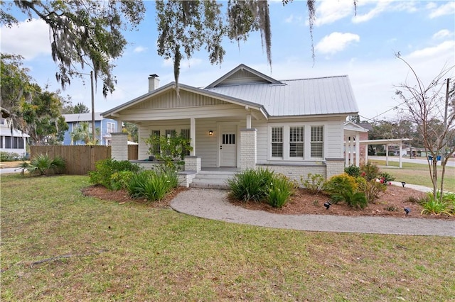 view of front of property with a porch and a front lawn