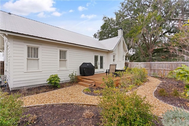 rear view of property featuring a wooden deck