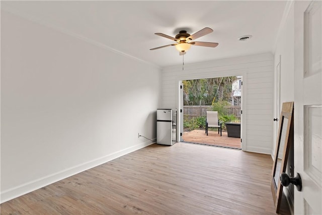 spare room with ceiling fan and wood-type flooring