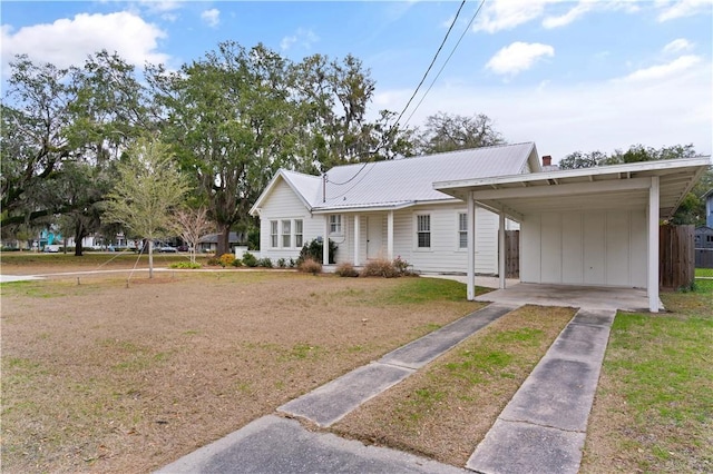 view of front facade with a front lawn and a carport