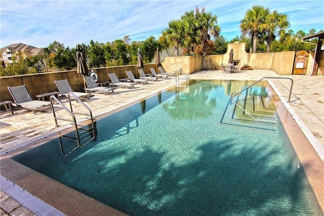 view of swimming pool featuring a patio area