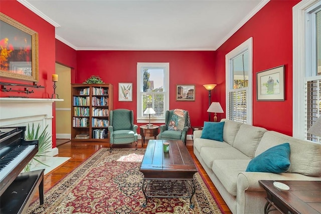 living room with a fireplace with flush hearth, wood finished floors, and ornamental molding