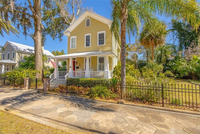 view of front facade featuring a fenced front yard and covered porch