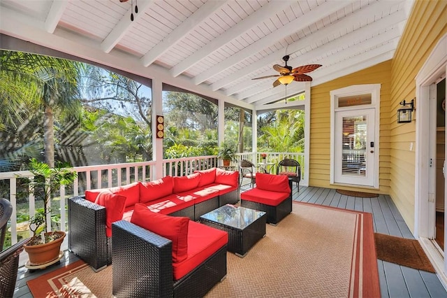 sunroom with vaulted ceiling with beams and a ceiling fan