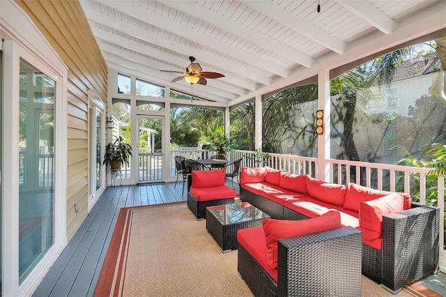 sunroom / solarium featuring lofted ceiling with beams and a ceiling fan