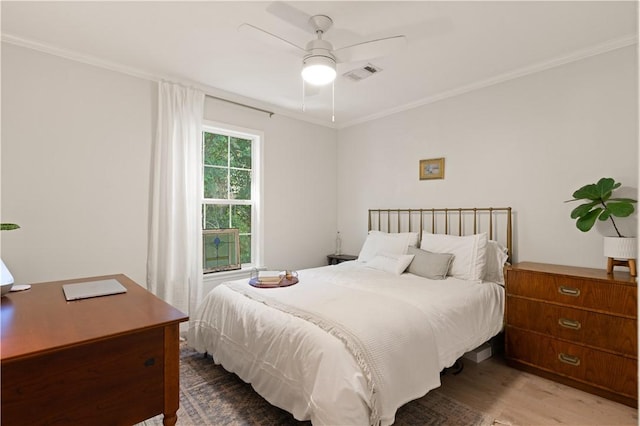 bedroom with hardwood / wood-style flooring, ceiling fan, and crown molding