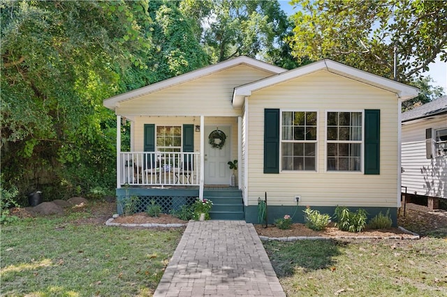 view of front facade with a front lawn and a porch