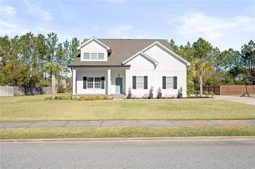 modern inspired farmhouse with a front lawn