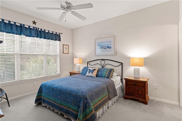 bedroom with ceiling fan and light colored carpet