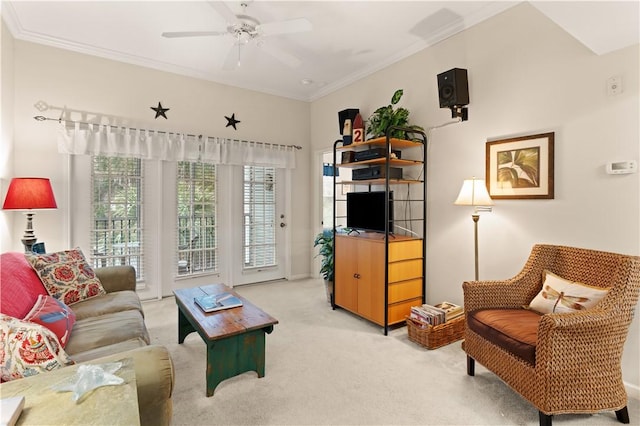 living room featuring ceiling fan, light colored carpet, and crown molding