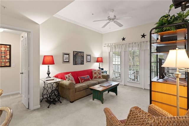 living room featuring ceiling fan, light colored carpet, and ornamental molding