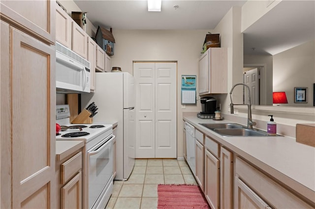 kitchen with light brown cabinets, white appliances, sink, and light tile patterned floors