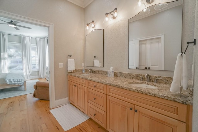 bathroom featuring ceiling fan, vanity, and hardwood / wood-style flooring