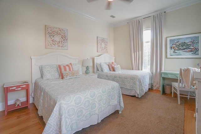 bedroom with ceiling fan, light hardwood / wood-style floors, and crown molding