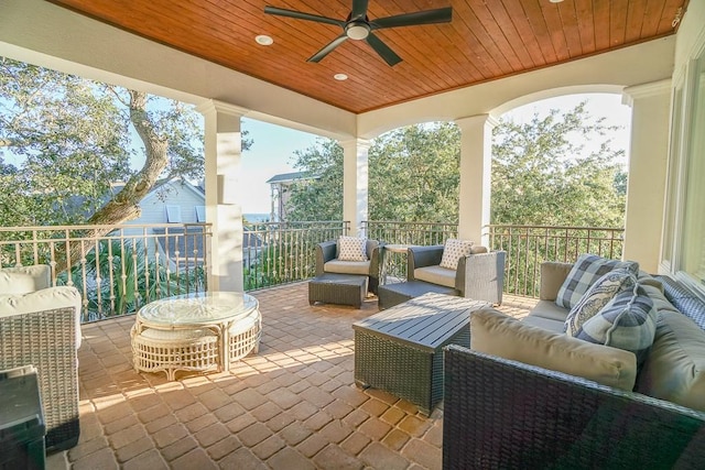 view of patio with ceiling fan and an outdoor living space